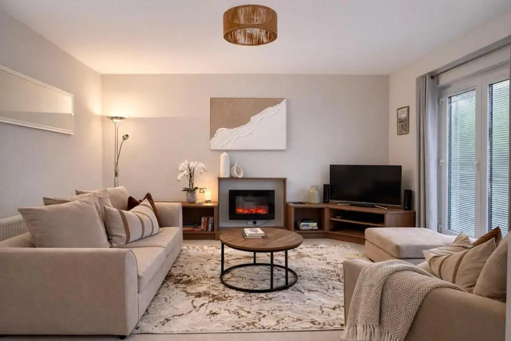 a living room with a couch and a tv at Ness Garden in Inverness