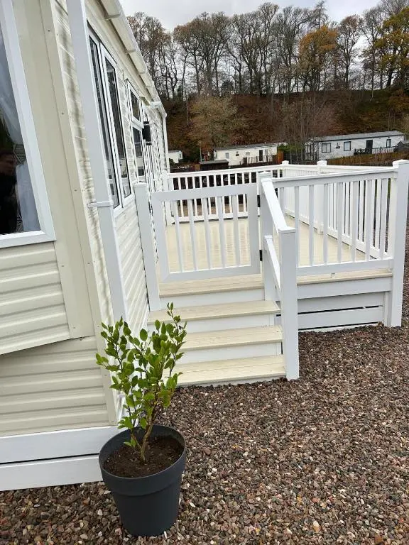 a potted plant sitting in front of a white house at Annas Escape Burnside Moray in Fochabers