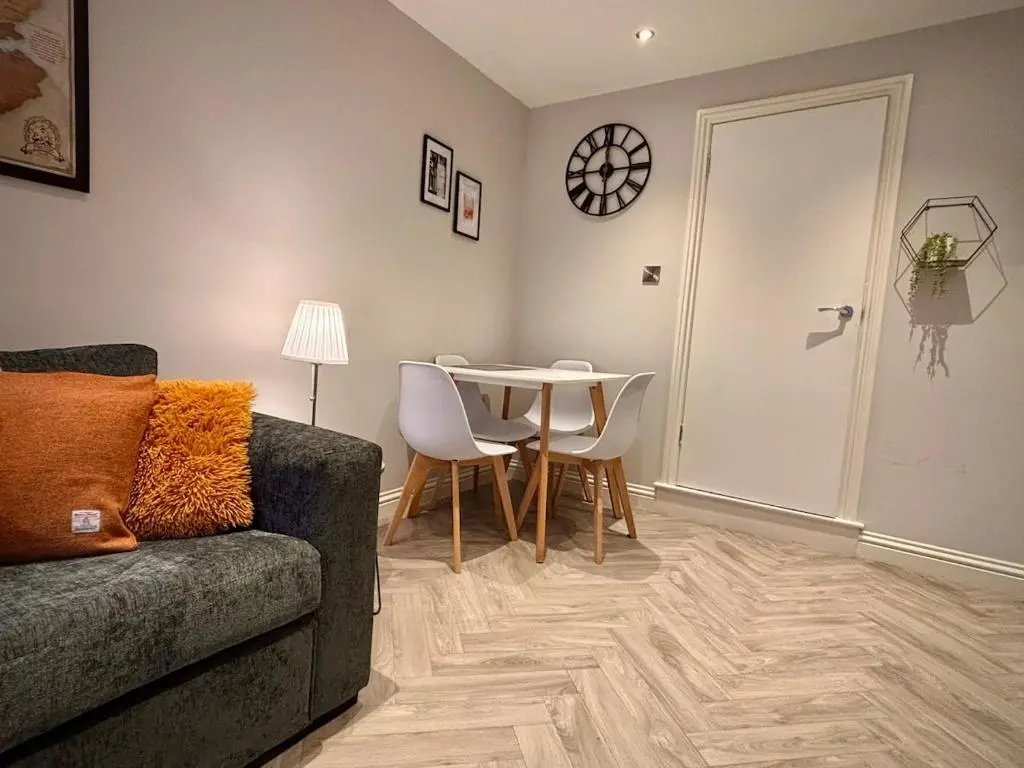 a living room with a couch and a table at Cosy cottage in idyllic Speyside setting in Rothes