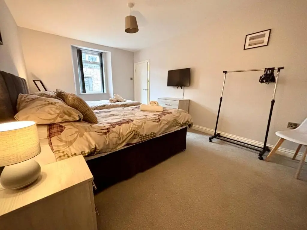 a bedroom with a bed and a desk with a lamp at Stunning Speyside retreat, ideal for Whisky lovers in Rothes