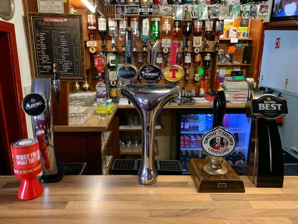 a bar counter with a bartender at Grant Arms Hotel in Cullen