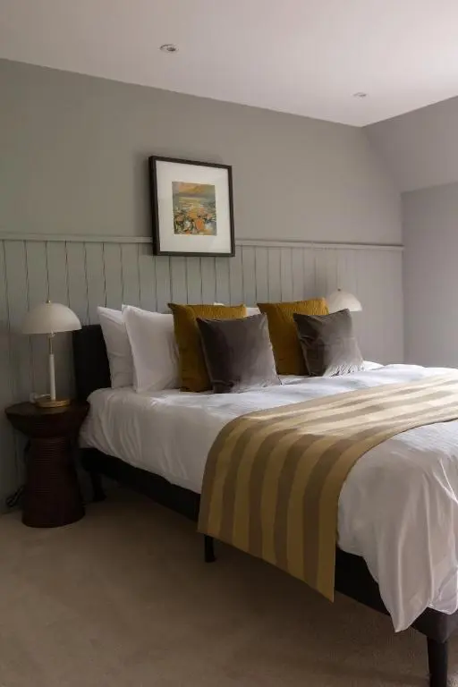 a bedroom with a large bed with pillows at Luxury Farmhouse, near Dornoch
