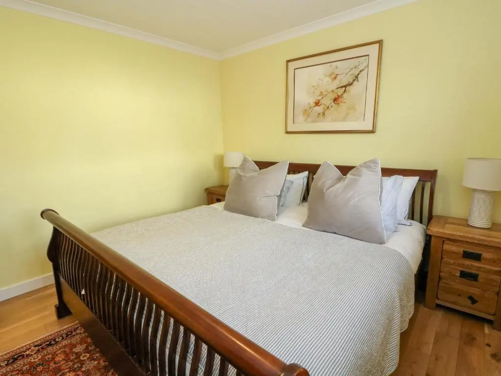 a bedroom with a bed with white sheets and pillows at 78 Findhorn in Forres