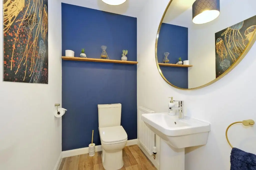 a bathroom with a white toilet and a mirror at A comfortable and modern 2BR 2BA home near ABZ in Inverurie