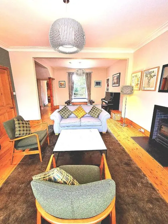 a living room with a couch and a table at 42 in the Crown in Inverness