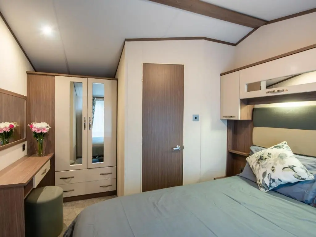 a bedroom with a bed and a desk and a cabinet at Holiday Home ScottishHighlands-LochNess by Interhome in Fort Augustus