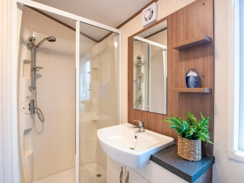 a bathroom with a sink and a glass shower at Holiday Home ScottishHighlands-LochNess by Interhome in Fort Augustus