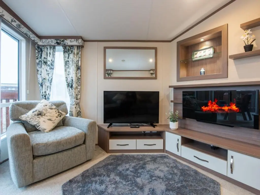 a living room with a tv and a fireplace at Holiday Home ScottishHighlands-LochNess by Interhome in Fort Augustus