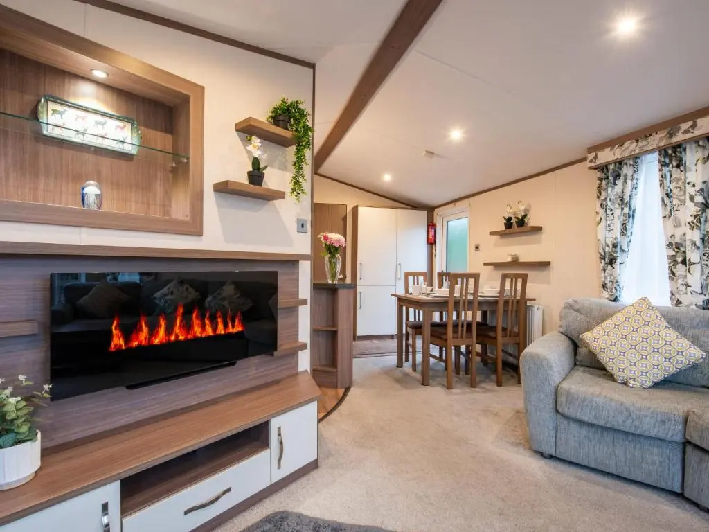 a living room with a fireplace and a couch at Holiday Home ScottishHighlands-LochNess by Interhome in Fort Augustus
