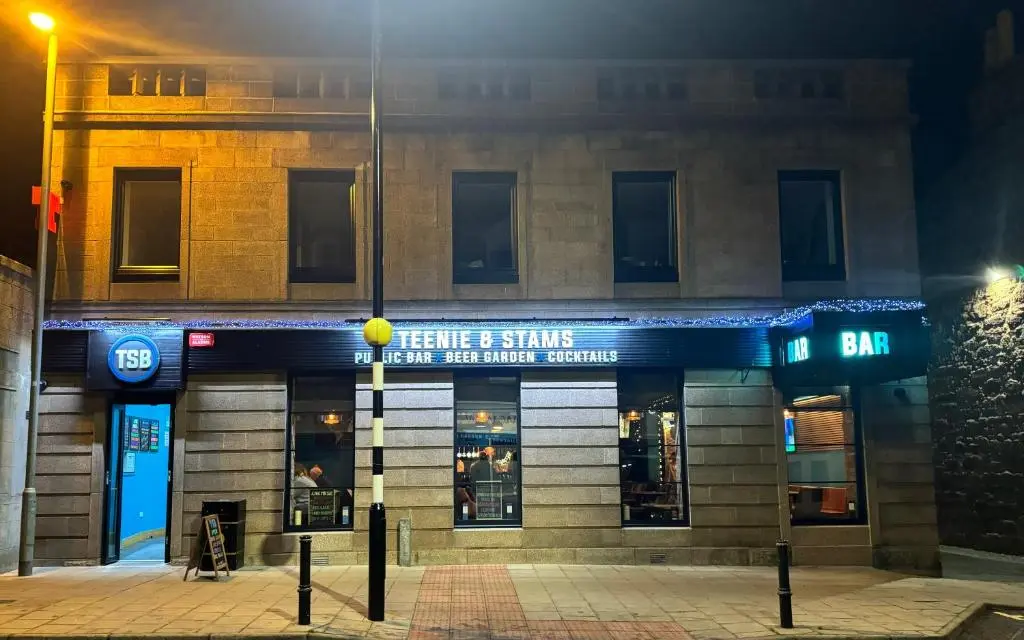 a store front of a building at night at TSB Rooms in Turriff