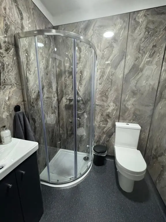 a bathroom with a shower and a toilet at TSB Rooms in Turriff