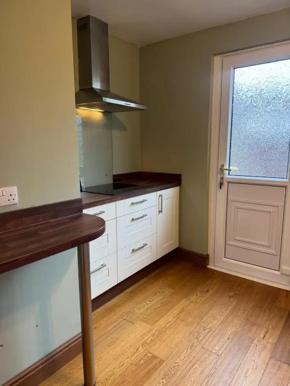 an empty kitchen with white cabinets and a window at Aberdeen Home near City in Aberdeen