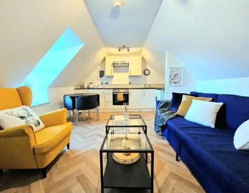 a living room with a blue couch and a table at Inverness City Escape! in Inverness