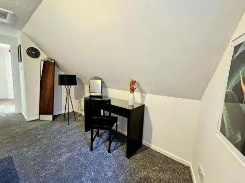 a room with a desk with a computer on it at Inverness City Escape! in Inverness