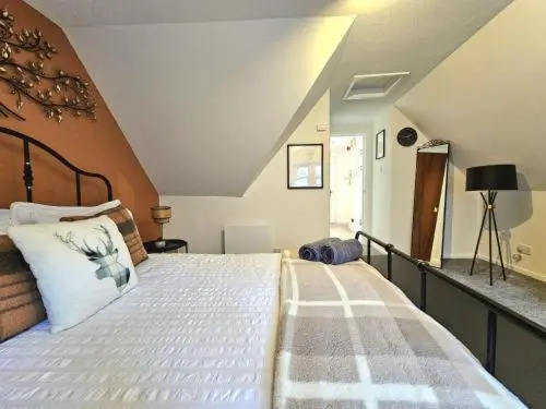 a bedroom with a large bed in a attic at Inverness City Escape! in Inverness