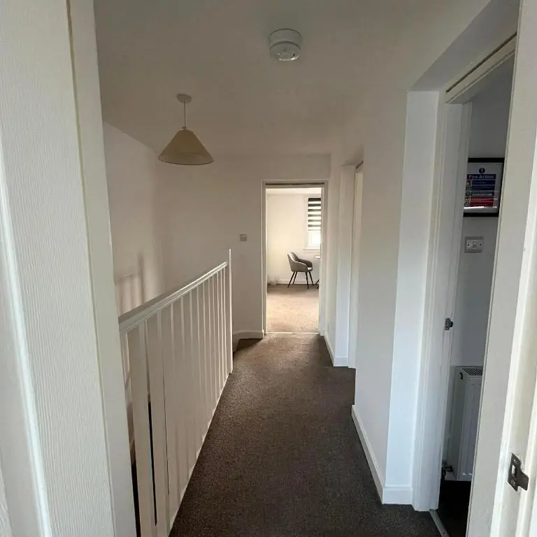 an empty hallway with a staircase in a house at Evan Barron Apartment, Inverness in Inverness