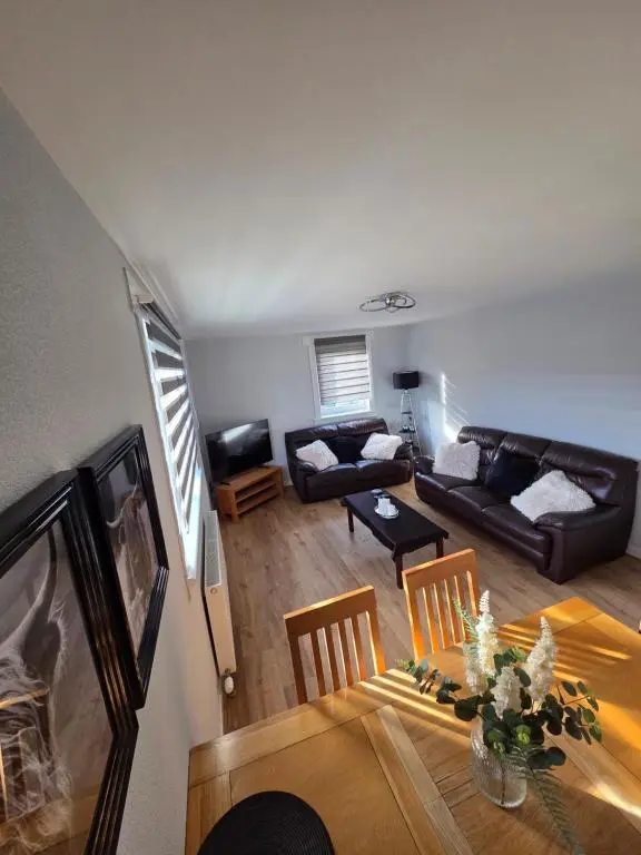 a living room with a table and a couch at Evan Barron Apartment, Inverness in Inverness