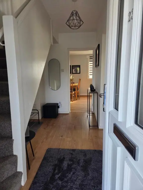 a hallway with a stairway with a stair case at Evan Barron Apartment, Inverness in Inverness