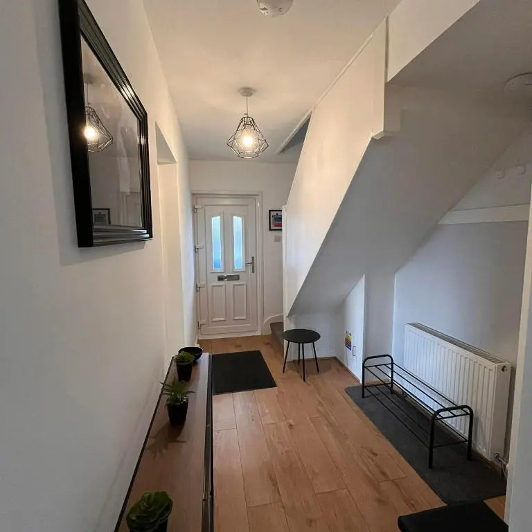 a hallway with a stairway with a stair case at Evan Barron Apartment, Inverness in Inverness