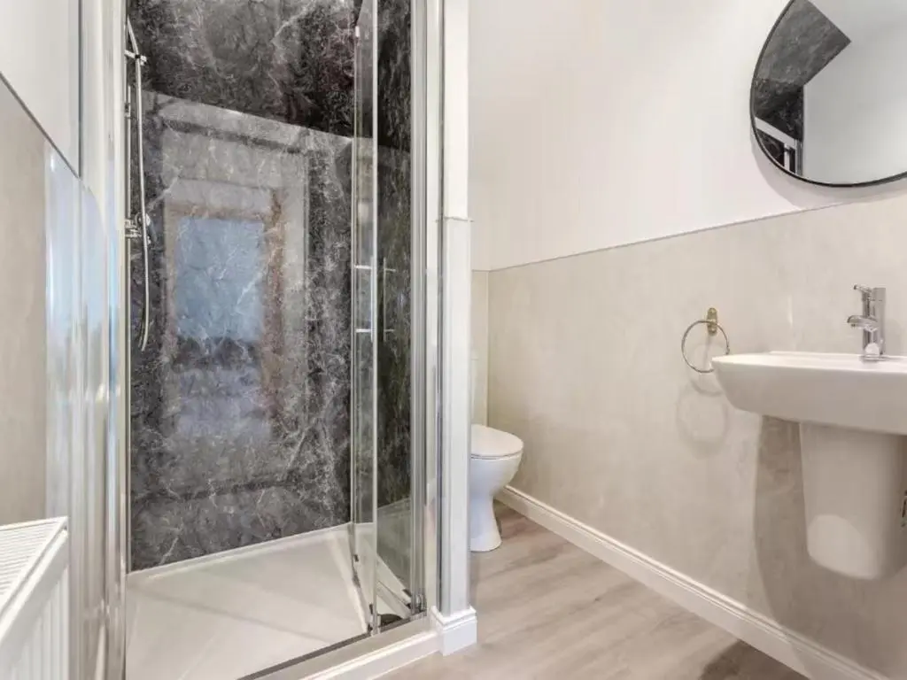 a bathroom with a shower and a sink and a toilet at Family - Central - Wifi - Parking - Sleeps 4 in Inverness