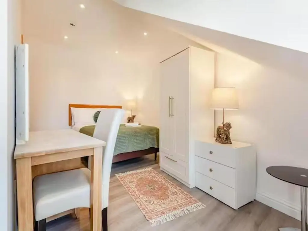 a bedroom with a bed and a desk with a table at Family - Central - Wifi - Parking - Sleeps 4 in Inverness