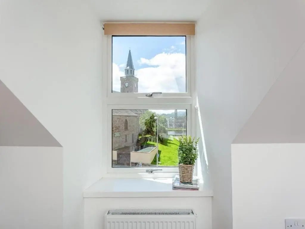 a window with a view of a church at Family - Central - Parking - Wifi - Sleeps 3 in Inverness