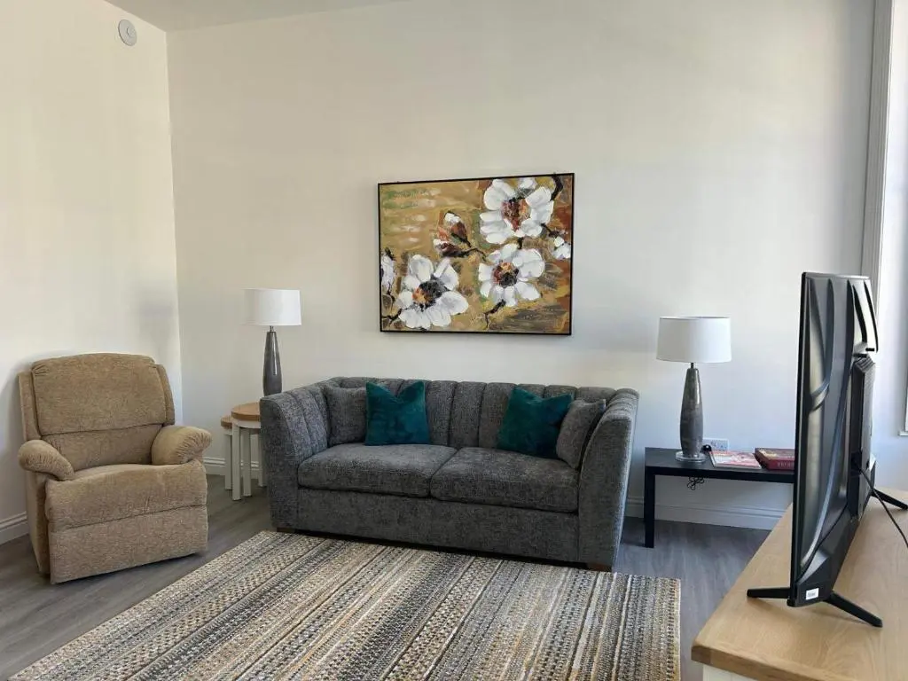 a living room with a couch and a chair at Family - Parking - Central - Wifi - Sleeps 4 in Inverness