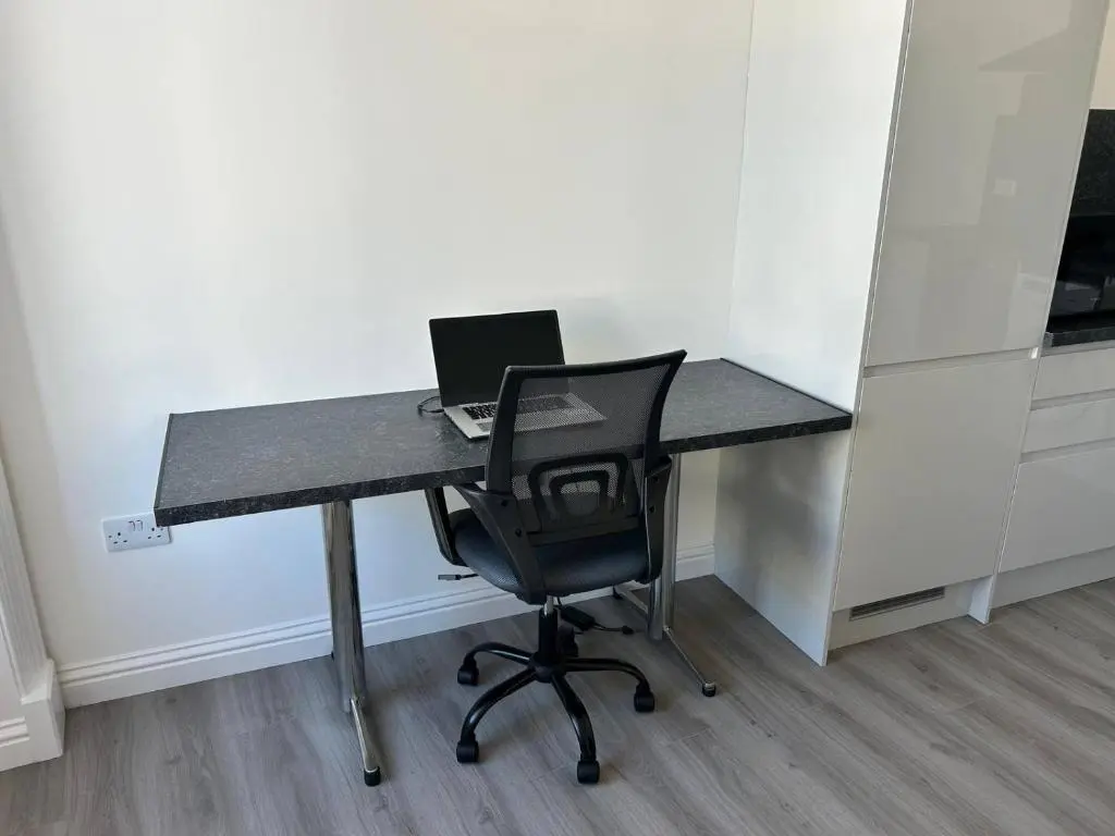 an office desk with a laptop computer on it at Family - Parking - Central - Wifi - Sleeps 4 in Inverness
