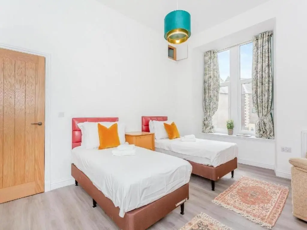 a bedroom with two beds and a window at Family - Central - Parking - Wifi - Sleeps 4 in Inverness