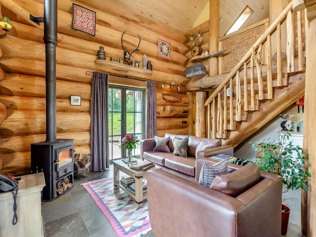 a living room with a couch and a fireplace at Sylvia - Uk50065 in Struy