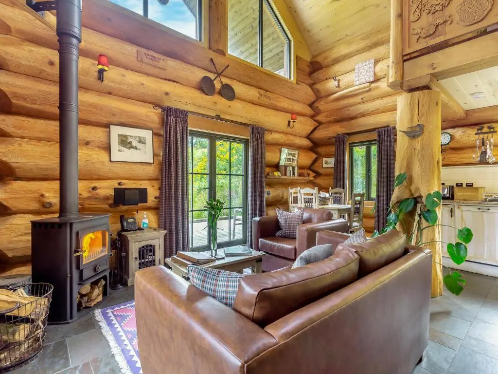 a living room with a couch and a fireplace at Strix - Uk50082 in Struy
