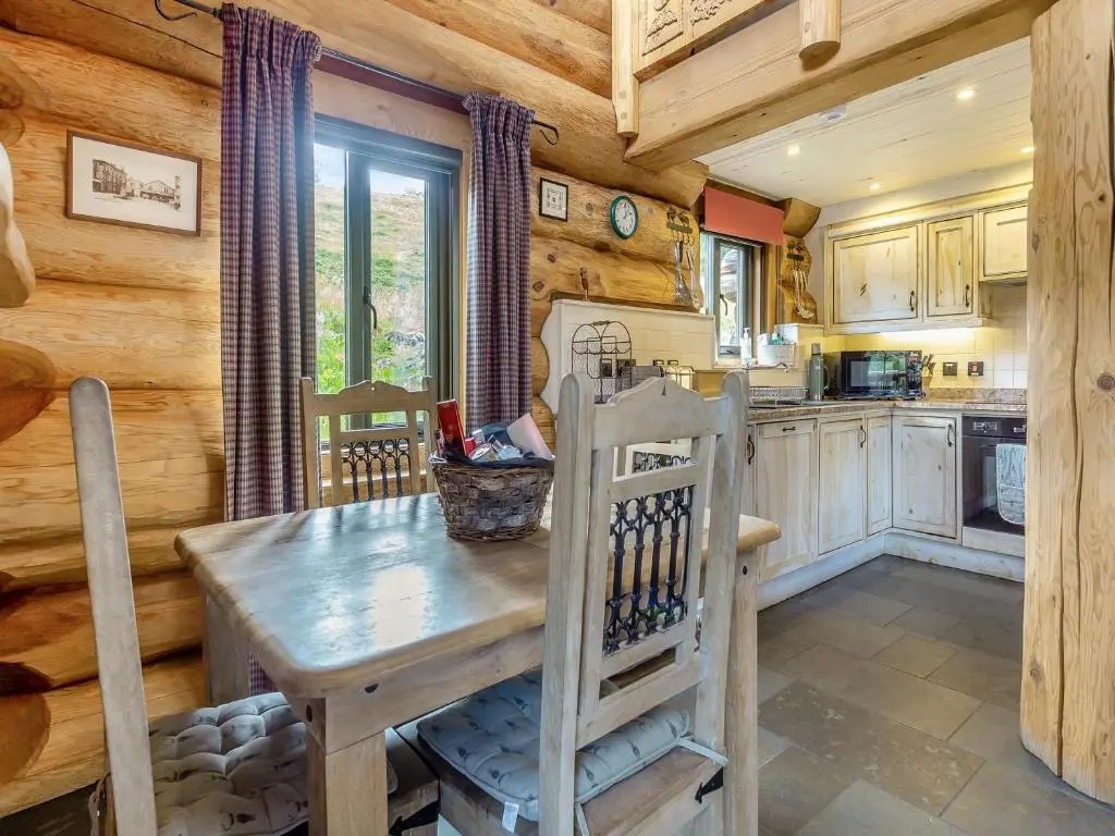 a kitchen with a wooden table in a cabin at Strix - Uk50082 in Struy
