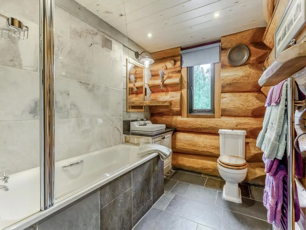 a bathroom with a tub and a toilet and a sink at Parus - Uk50083 in Beauly