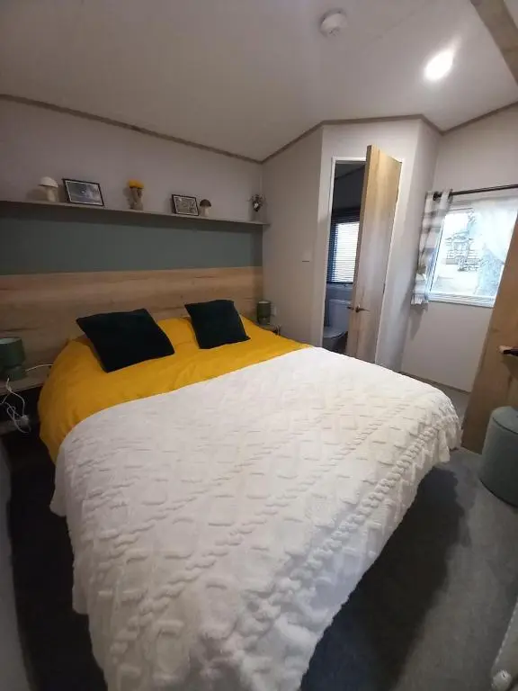 a bedroom with a large white bed with two pillows at Boat 32 in Boat of Garten