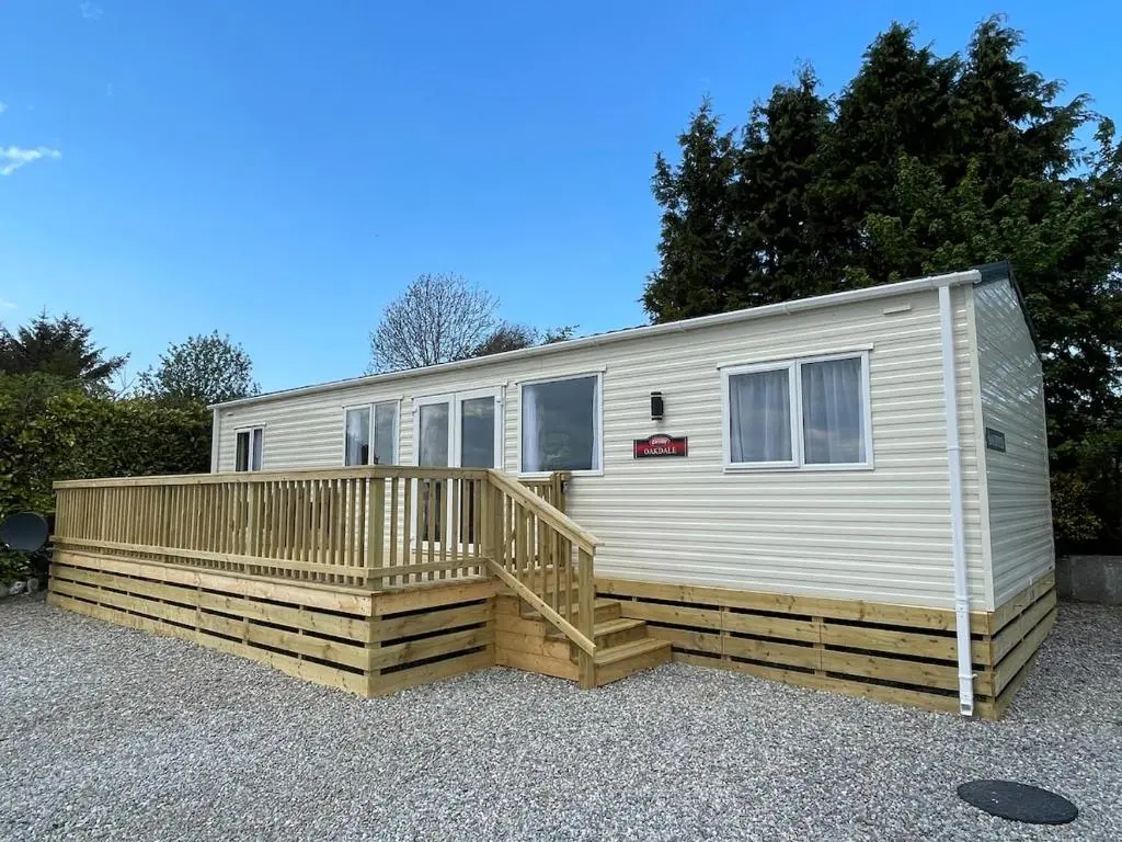 a mobile home with a porch and a deck at Brand New Beautiful Home close to Inverness in North Kessock