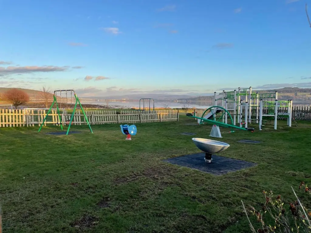 a park with a playground with a slide at Brand New Beautiful Home close to Inverness in North Kessock