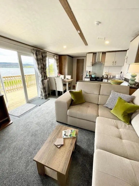a living room with a couch and a table at Brand New Beautiful Home close to Inverness in North Kessock