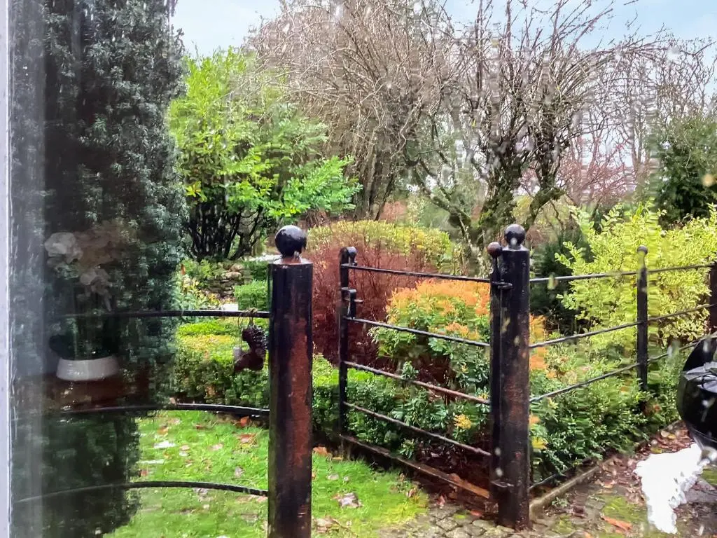 an old iron gate with a garden behind it at Uppermill Farm in Tarves