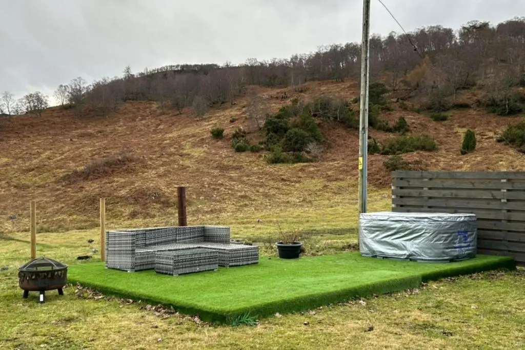 a yard with green grass and a hill at Hot tub - Garden - Bbq - Parking - Pets - Sleeps 6 in Strathpeffer