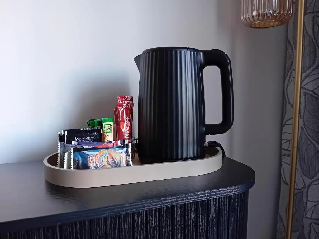 a black pot sitting on top of a table with snacks at The Snug on The Brae in Inshes