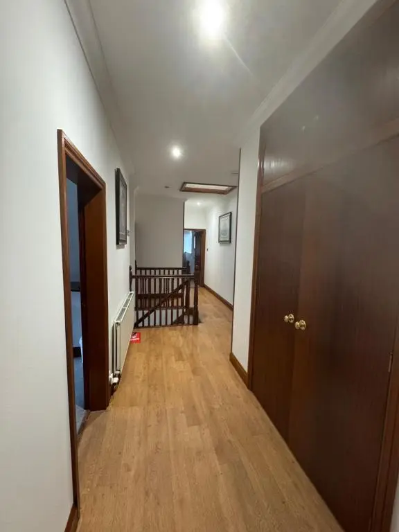 a hallway with a door and a room with a staircase at TSB Accommodation in Turriff