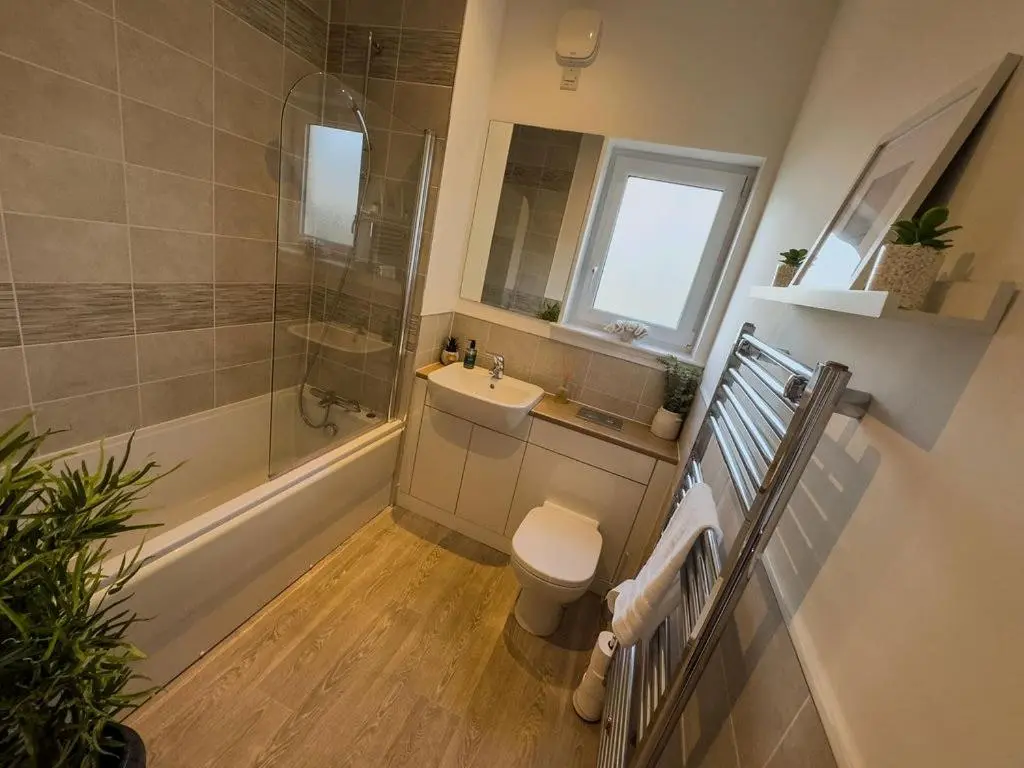 a bathroom with a toilet and a sink and a shower at Beinn View in Inverness