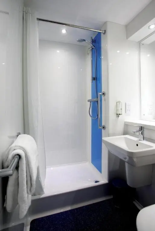 a bathroom with a shower and a sink at Travelodge Aberdeen Bucksburn in Aberdeen