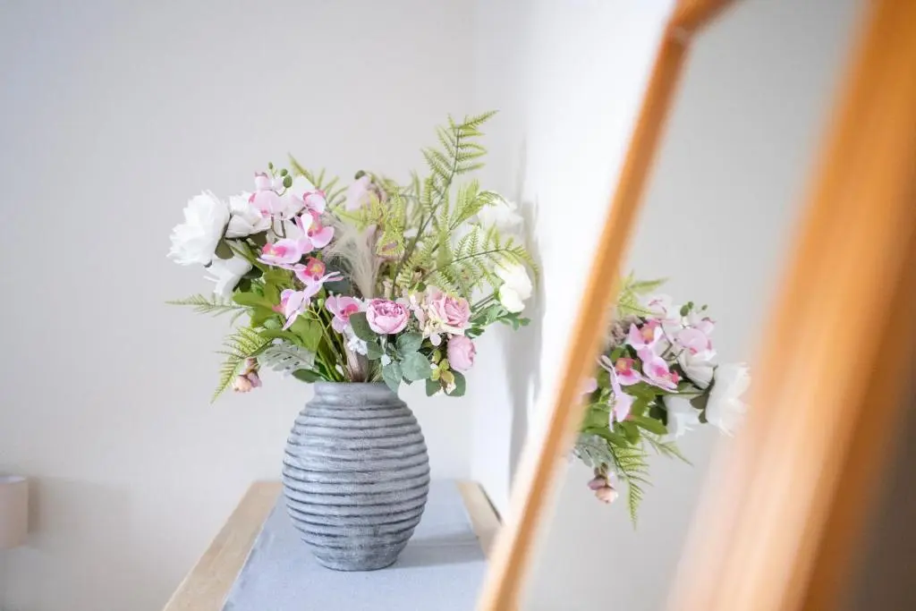 a vase filled with pink and white flowers on a table at Century House - 4BR - Free Parking - City Centre in Inverness