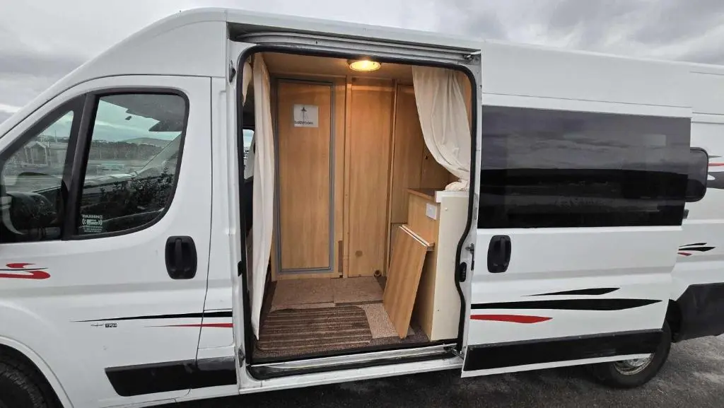 an open door of a white van with the door open at Rover Rentals in Inverness