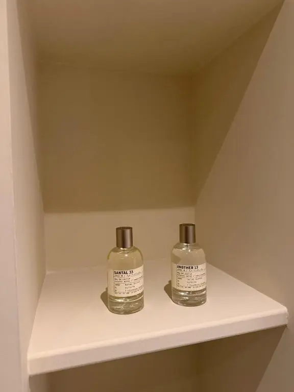 two bottles sitting on a shelf in a room at Gilchrist Square in Dornoch