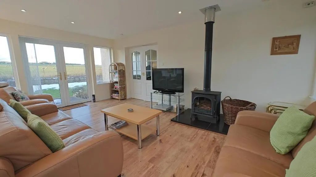a living room with a couch and a fireplace at 3 Bed in Drybridge oc-w34891