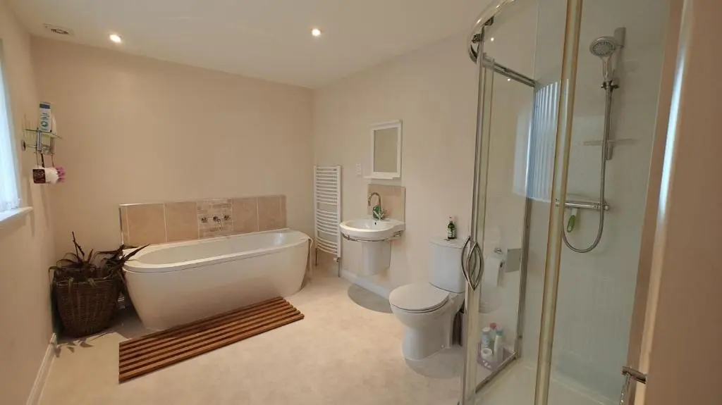 a bathroom with a tub and a toilet and a shower at 3 Bed in Drybridge oc-w34891