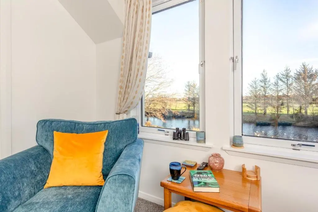 a living room with a blue couch and a table at 2 Bed in Nairn oc-t34496 in Nairn