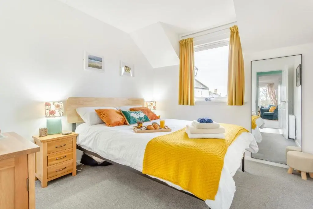a bedroom with a bed with a yellow blanket at 2 Bed in Nairn oc-t34496 in Nairn